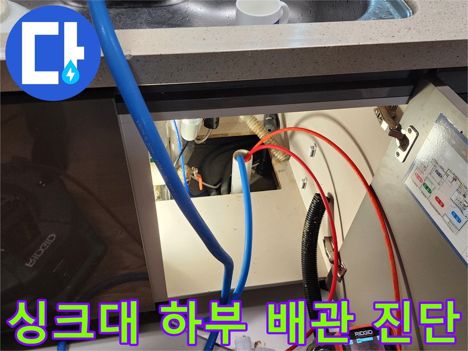 내시경 카메라 장비-싱크대 하부장 내부의 배관 상태를 파악하기 위해 검사 중인 장면입니다.