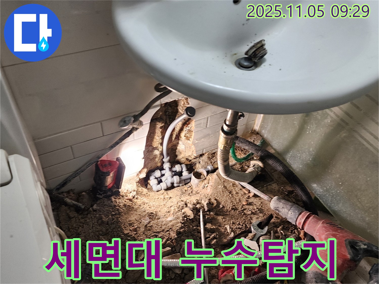 세면대 아래 누수 지점 - 벽 속 배관 연결 부위에서 누수 발생