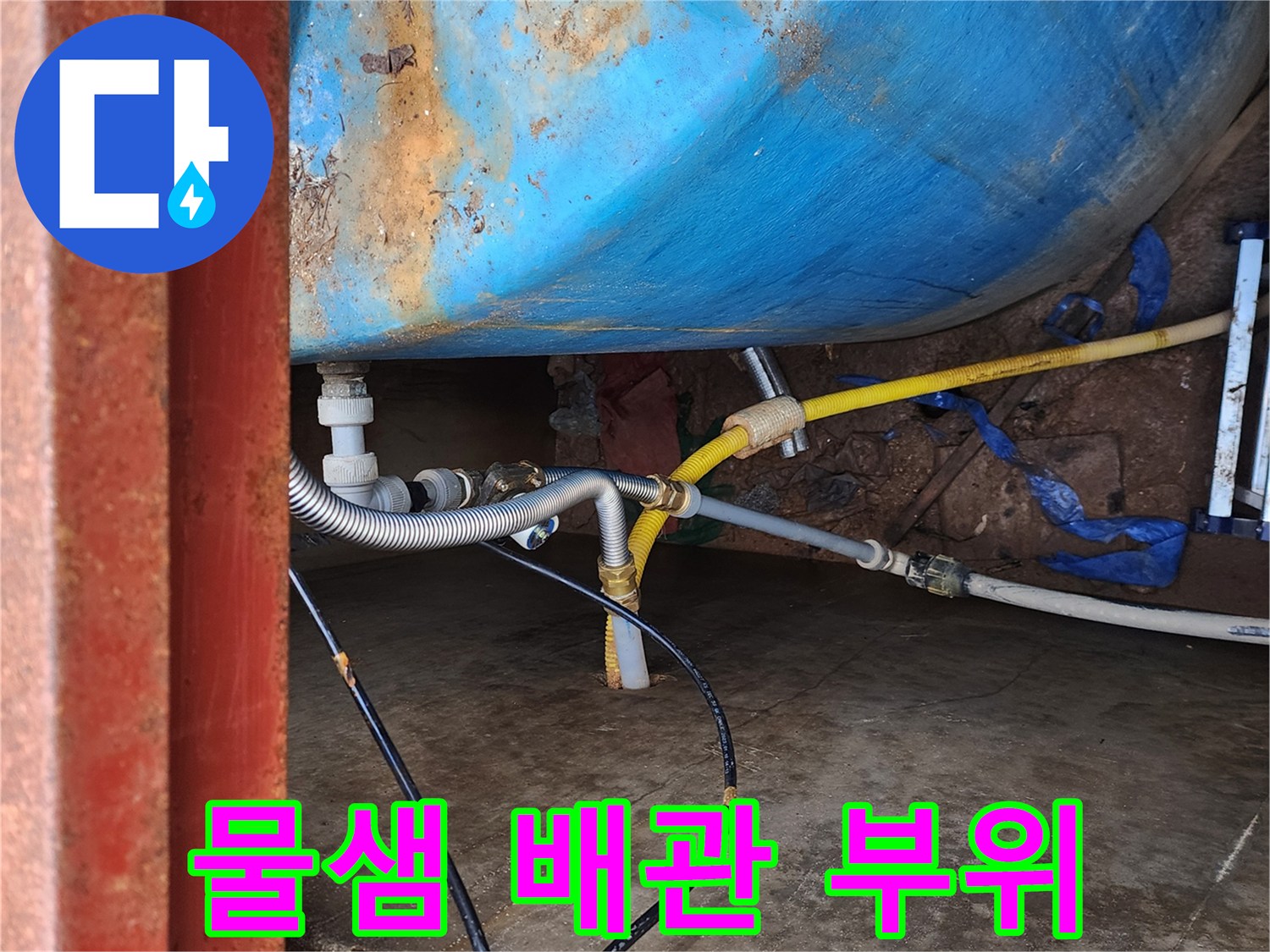 물탱크 외벽과 연결된 노란색 호스 및 은색 주름관 상세 사진