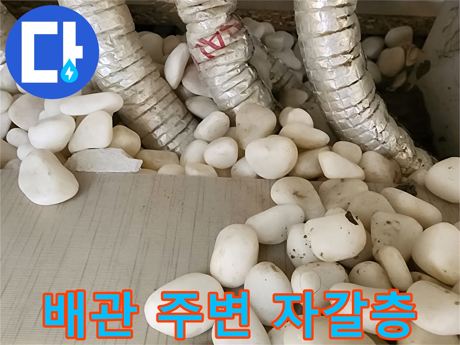 보온재로 감싸진 배관과 젖어있는 자갈층 상태