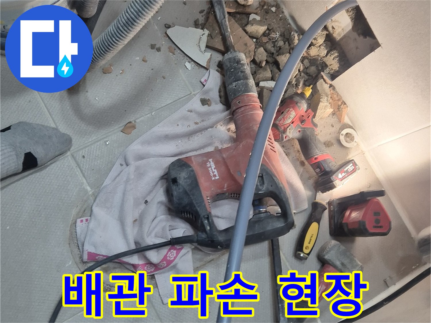 지행동 동양엔파트 아파트 누수 현장 - 망치질로 배관 파손 부위를 확인하는 이미지입니다.
