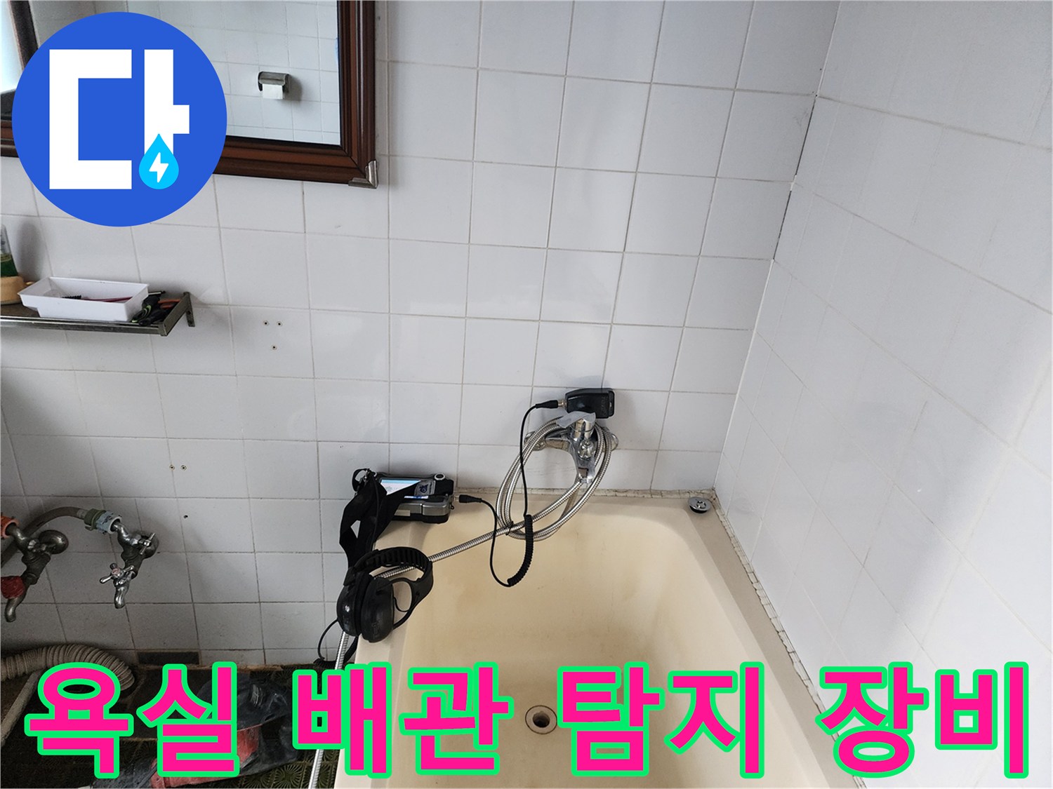 벽면 타일 틈새로 연결된 가스식 누수 탐지용 호스와 커넥터입니다.