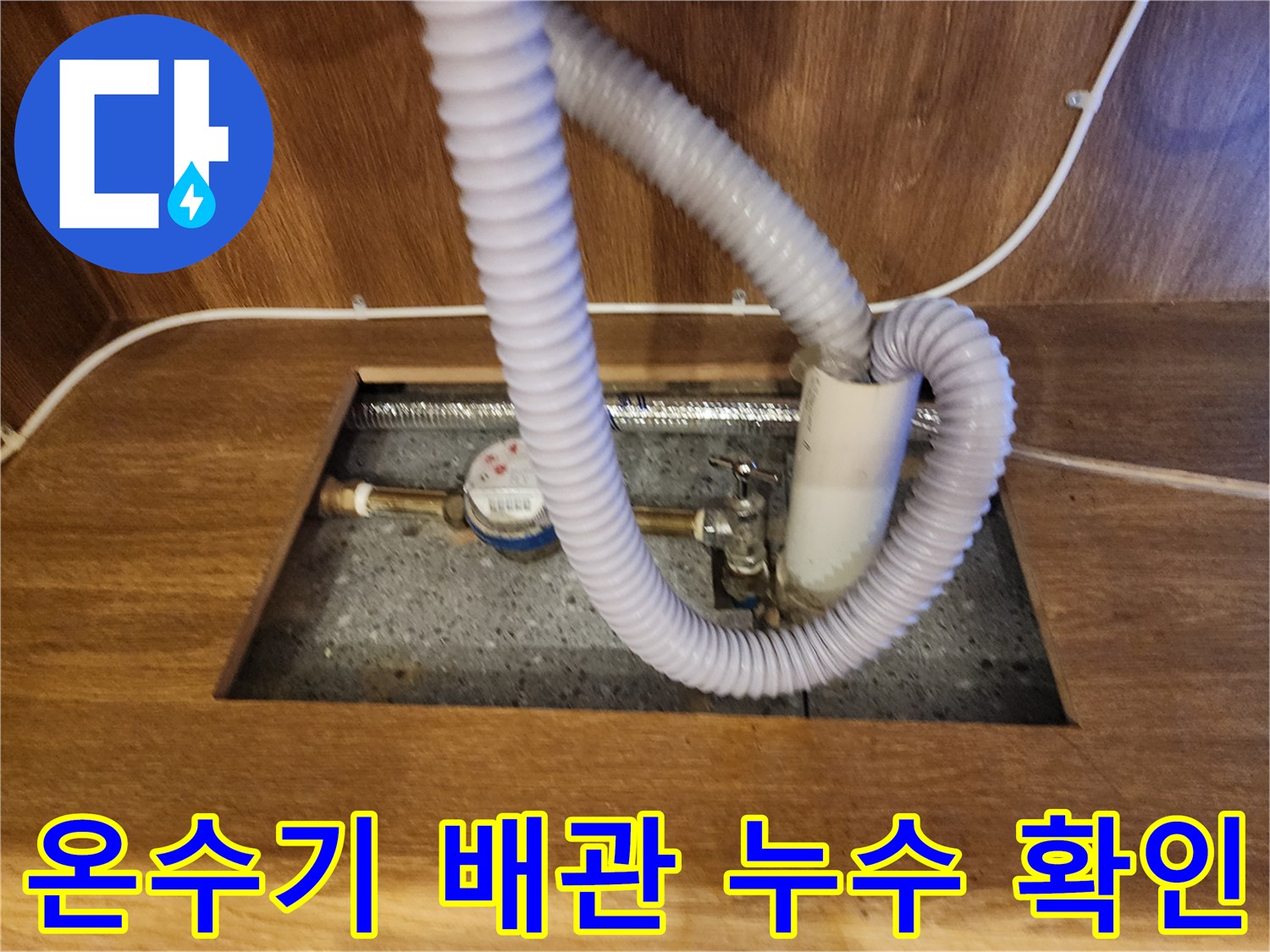 주방 하부장 내 설치된 전기 온수기의 배관 연결 부위 점검 사진