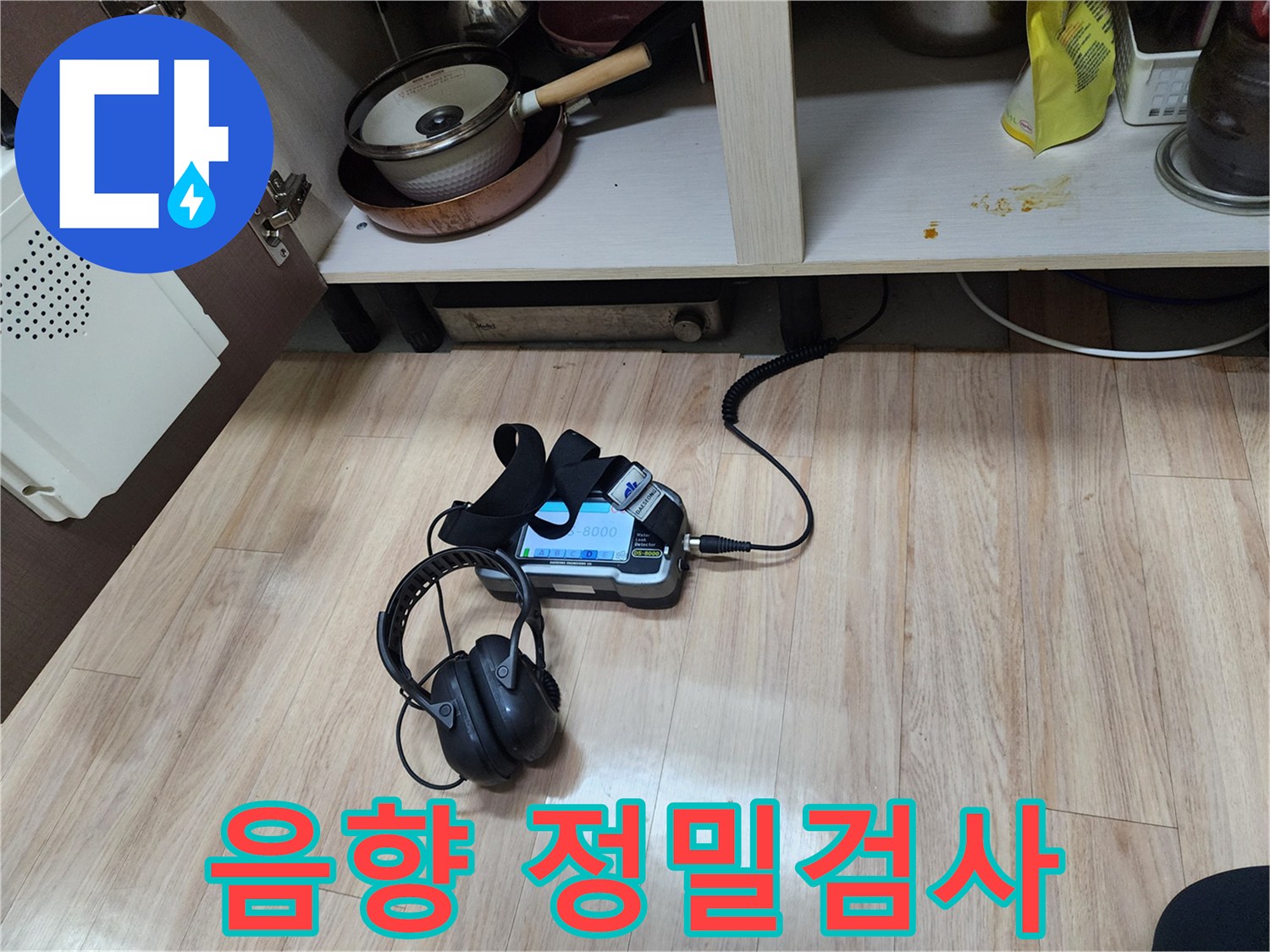 누수 지점을 정밀하게 검사하기 위해-음향 탐지기와-헤드폰을 함께 사용하여-꼼꼼하게 확인하는 과정입니다.
