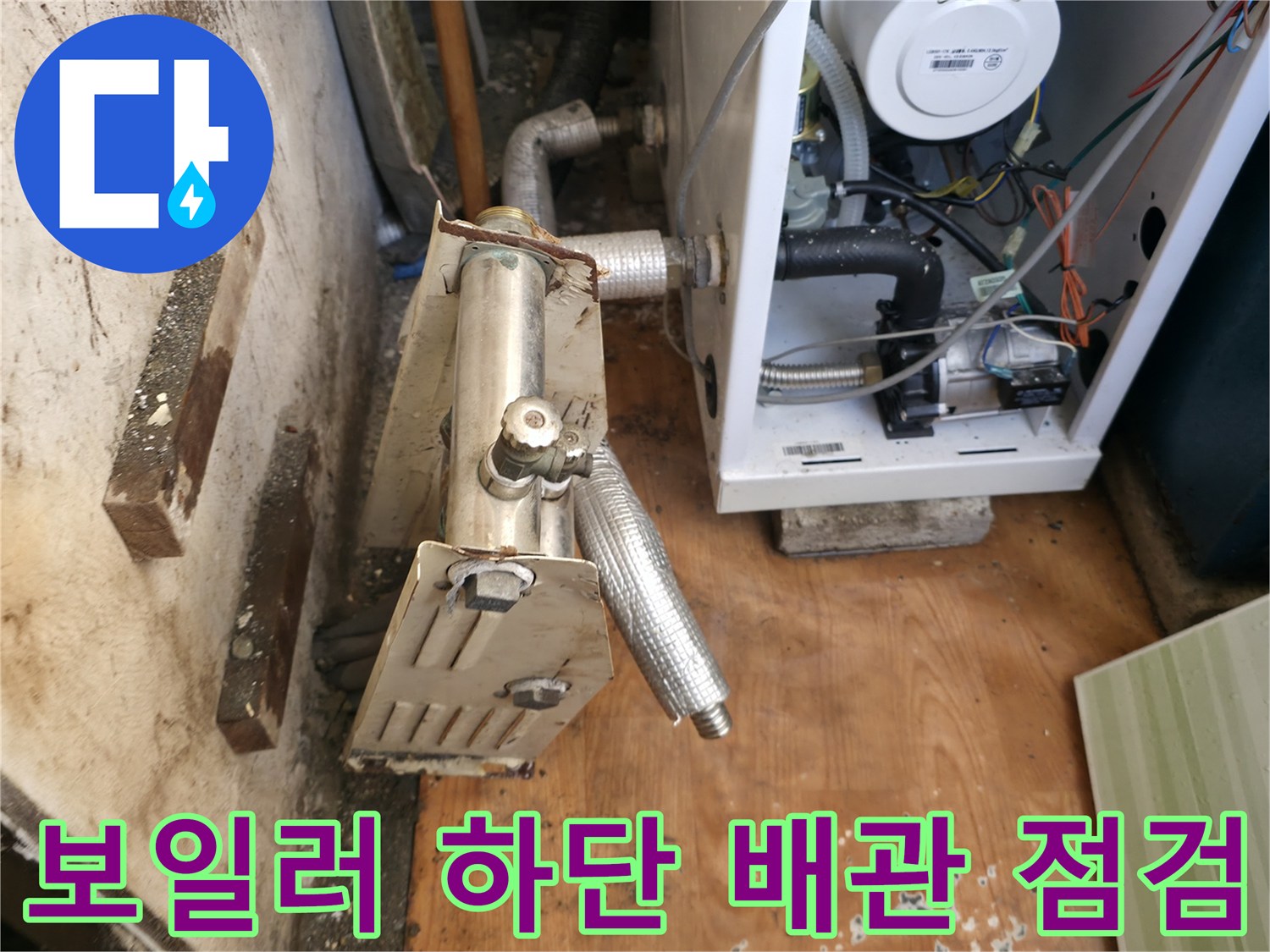 보일러 하단부 연결된 금속 배관과 컨트롤러 모습