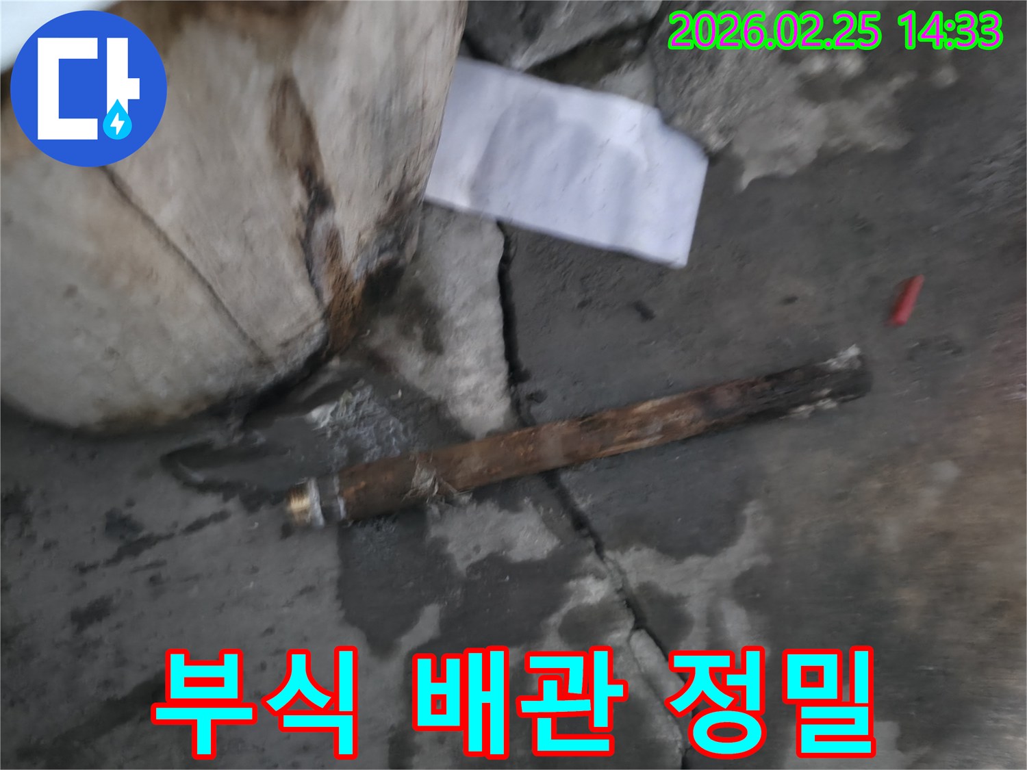 오래되어 심하게 부식된-파열된 배관이-젖은 땅속에서 발견된-누수 공사 현장 사진입니다.