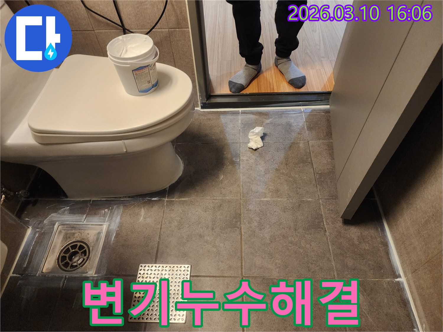 화장실 바닥 타일과 변기 주변의 누수 흔적을 찾아내는 초기 진단 과정입니다- 배수구 근처의 물기나 백시멘트의 변색 여부를 주의 깊게 관찰하고 있습니다.