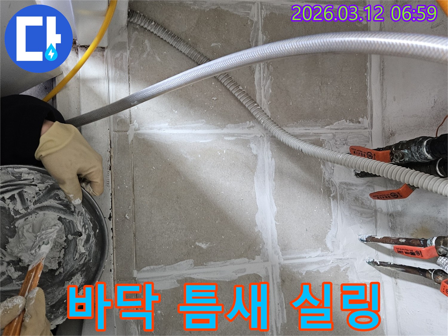 누수 엔지니어가 바닥 틈새에 누수 방지를 위한 고품질 실링재를 직접 손으로 꼼꼼하게 시공하고 있습니다
