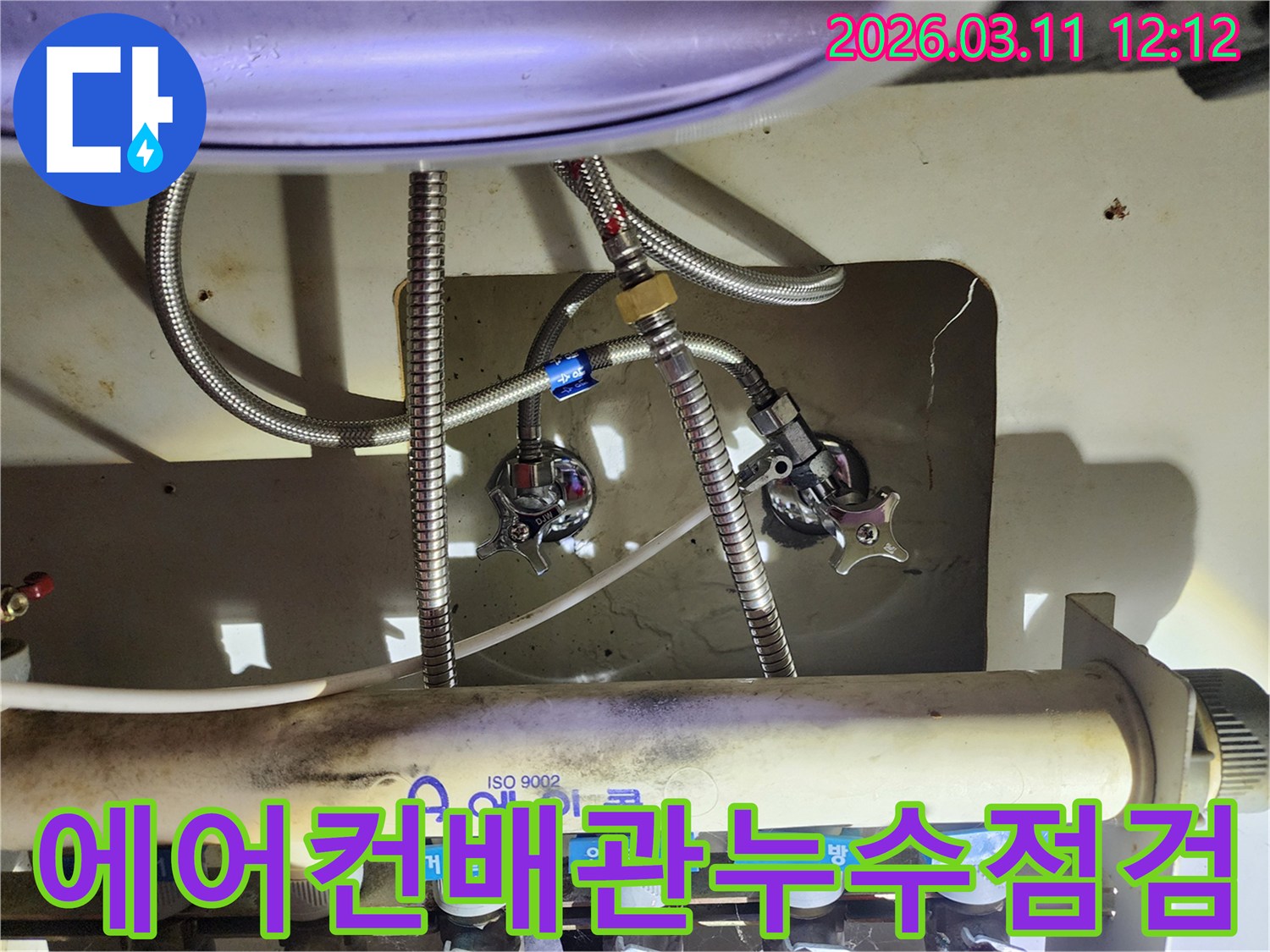 숙련된-엔지니어가-복잡한-수도-배관-연결부위의-누수-여부를-확인하는-장면