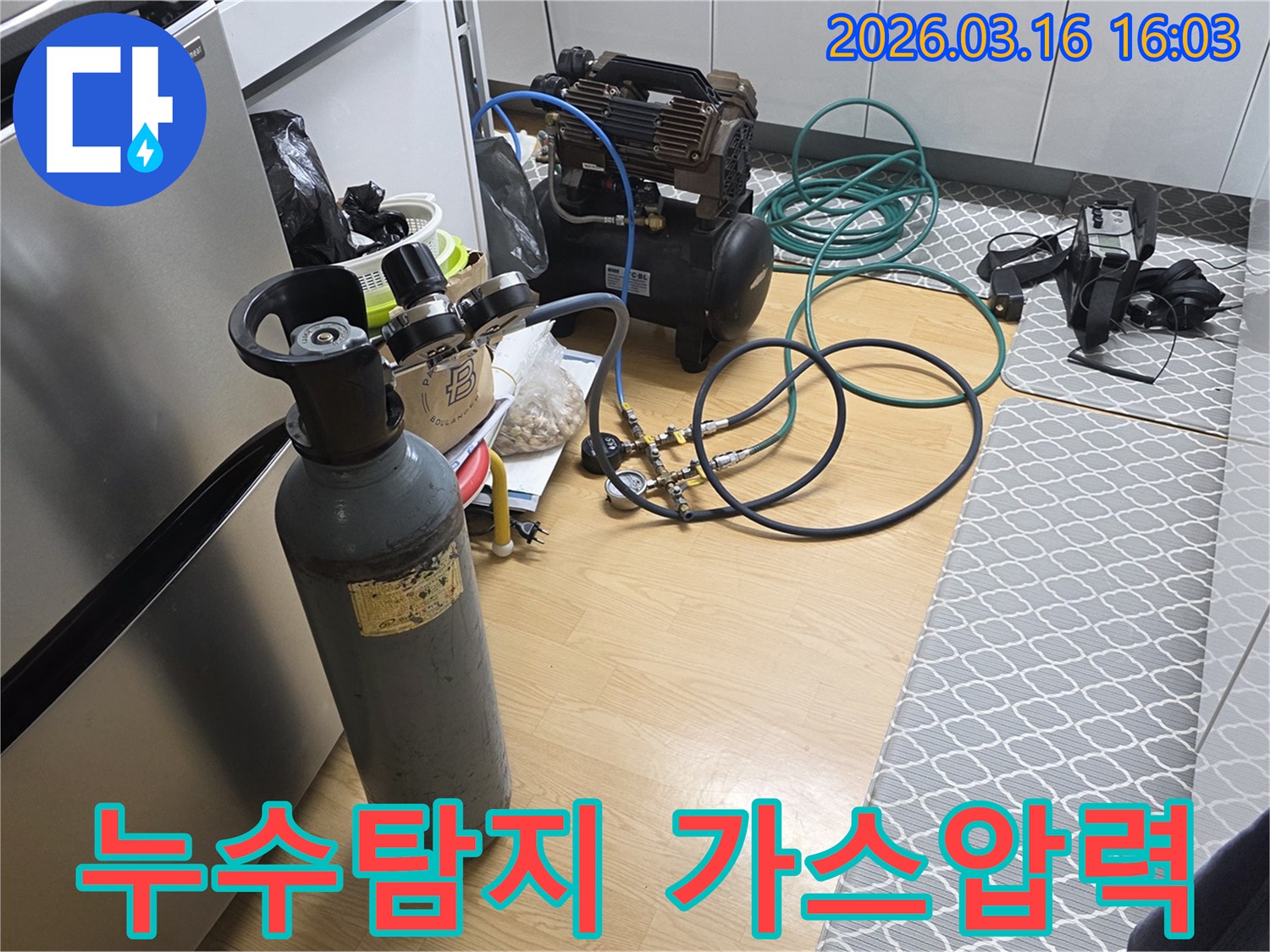 주택 화장실 누수 원인 파악을 위해-가스통과 압축기 등-전문 탐지 장비가 설치된 현장입니다