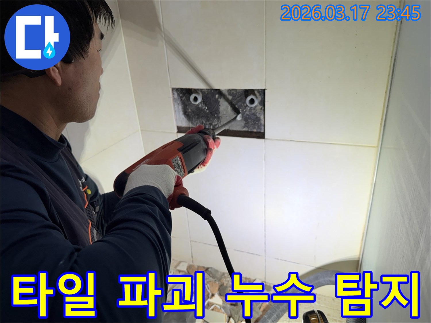 누수 전문가가 욕실 벽면 타일을 파괴하여-숨겨진 배관의 누수 지점을 정밀하게 탐지하는 작업 현장입니다.