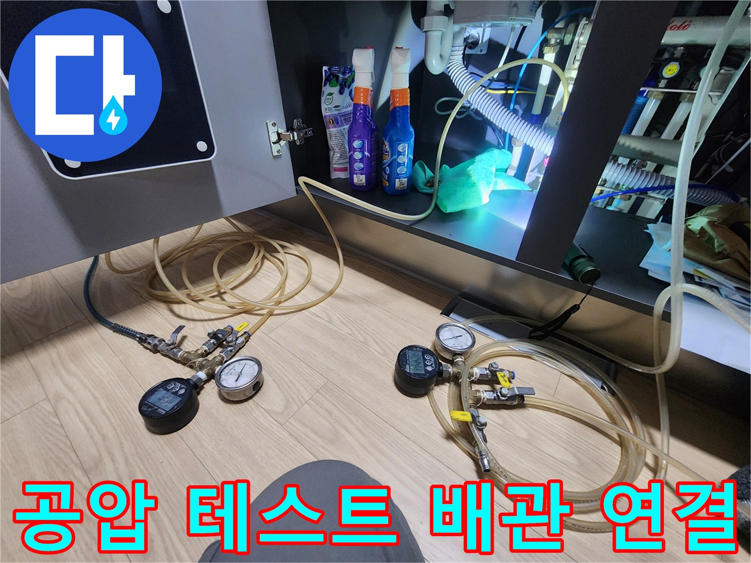 싱크대 아래 좁은 공간에 설치된 압력계와 가스 탐지 호스 세트