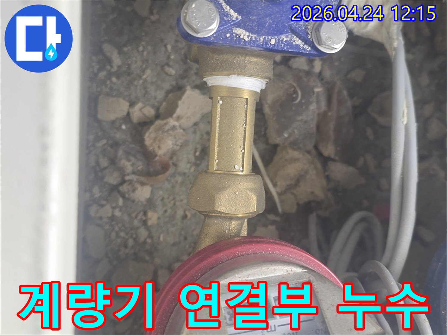 이 이미지는 수도 계량기와 배관 연결부에서 발생한 누수 문제를 보여줍니다-전문가가 누수 지점을 확인하는 과정입니다.