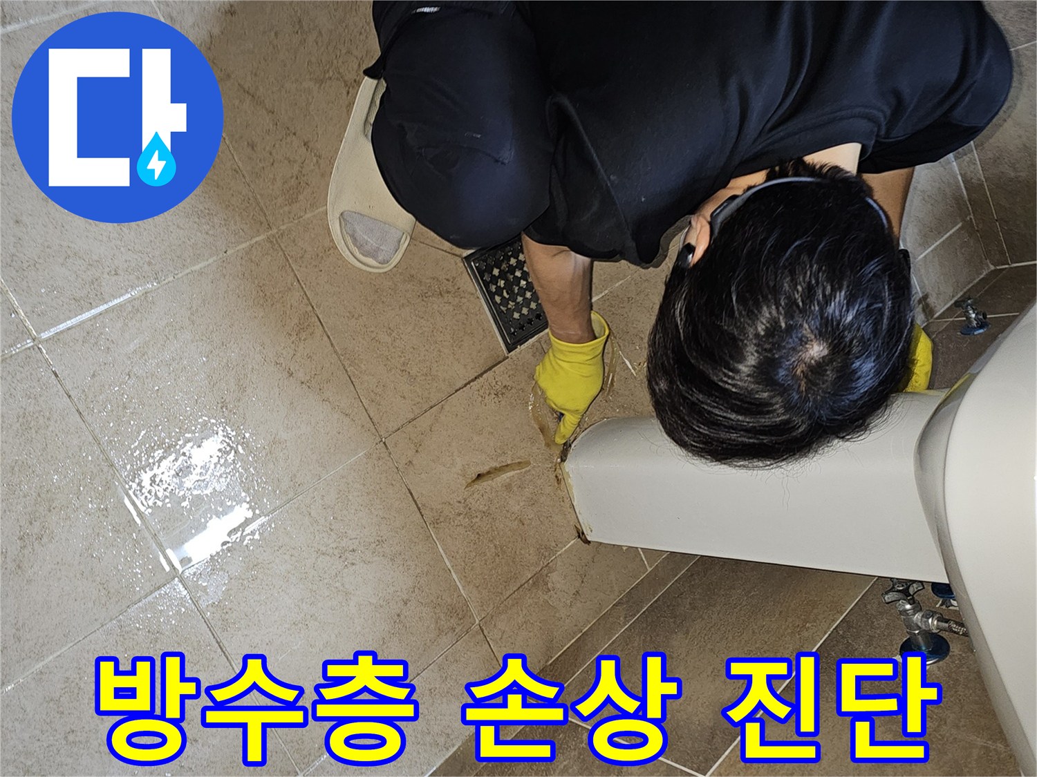 전문 엔지니어가-노란 장갑을 끼고-욕실 바닥의 젖은 타일과-세면대 하단부를-집중적으로 관찰하며-방수층 손상 가능성을 진단합니다