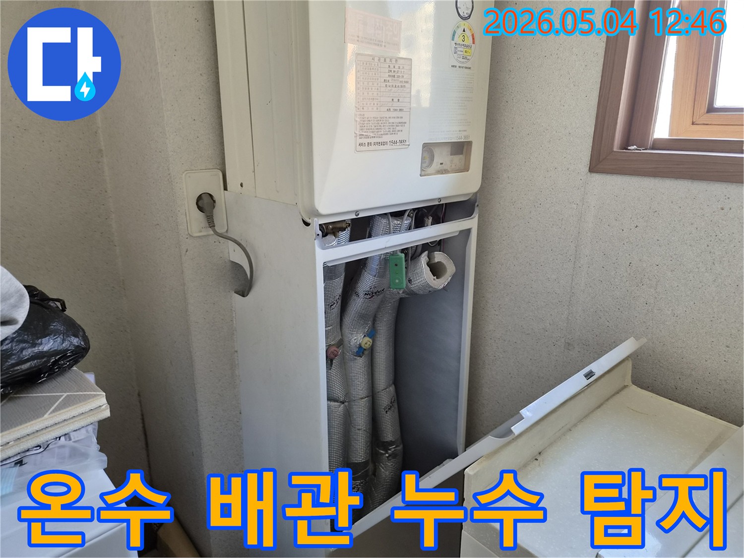 행당동 빌라 보일러실에서-온수 배관의 누수 여부를-정밀하게 탐지하기 위해-보일러 하단부를-개방하여 점검하는 모습입니다