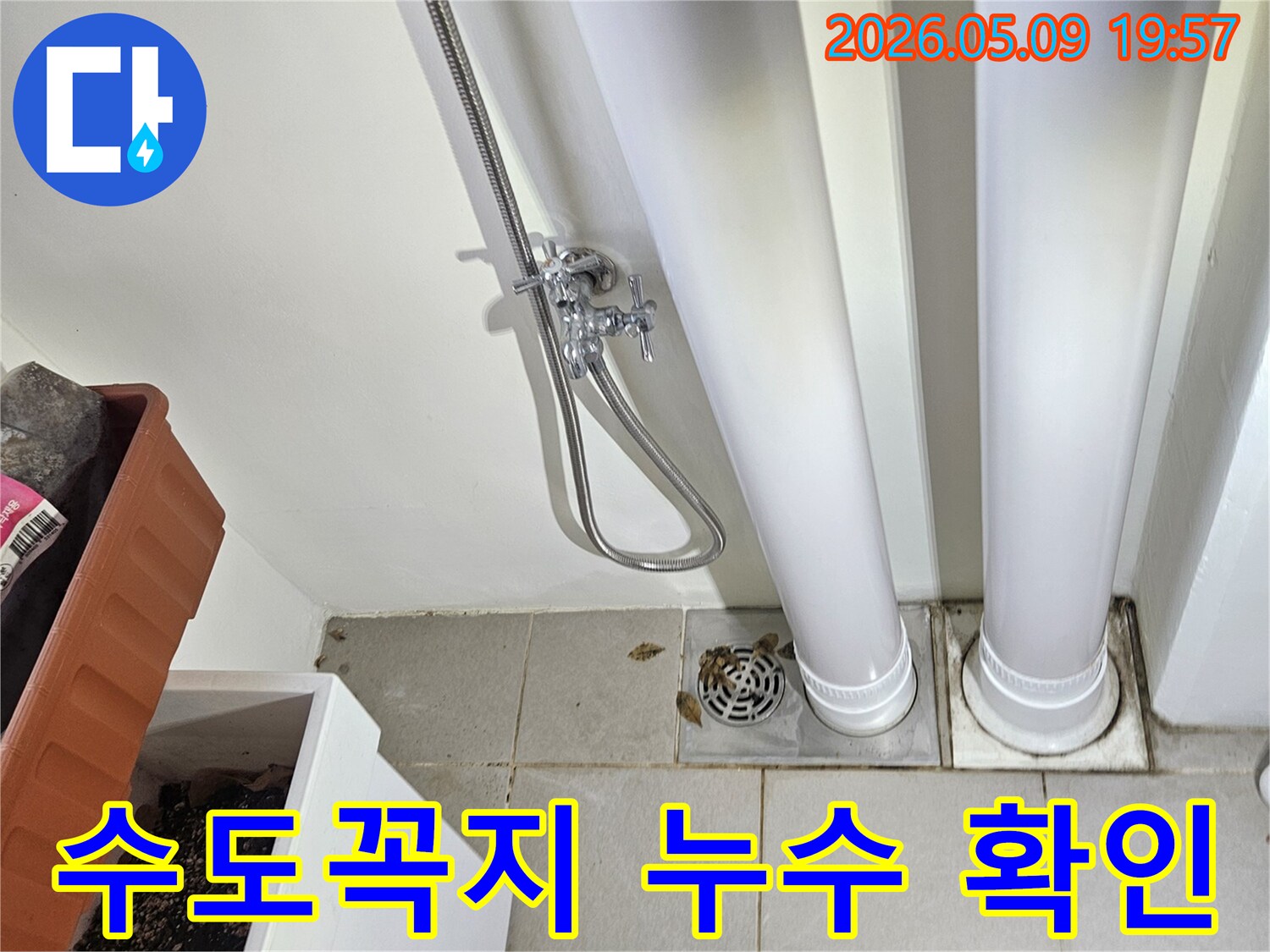 이 이미지는-욕실-벽면에-설치된-수도꼭지와-연결된-샤워-호스를-보여주며-누수-여부를-점검하고-있습니다