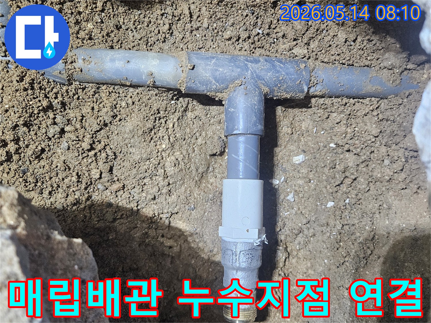 땅속에 묻힌 수도배관의 T자 연결부위에서 누수가 발생하여-새로운 부품으로 교체하는 모습입니다