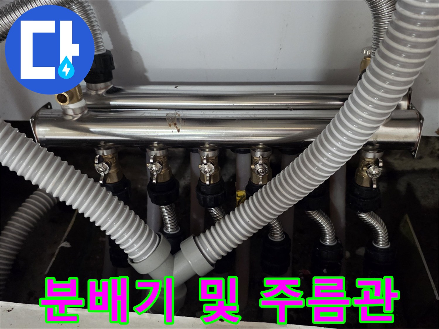 싱크대 아래 설치된 금속제 분배기와 연결 호스들