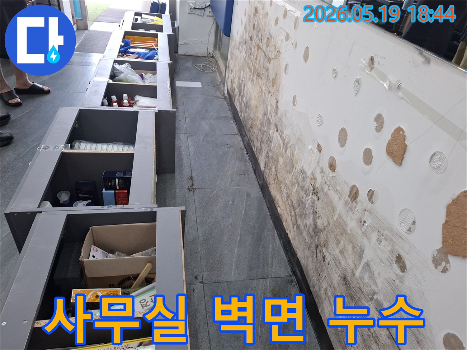사무실 벽면에 발생한 누수로 인해-벽지가 젖고 곰팡이가 심하게 번식한 현장 모습