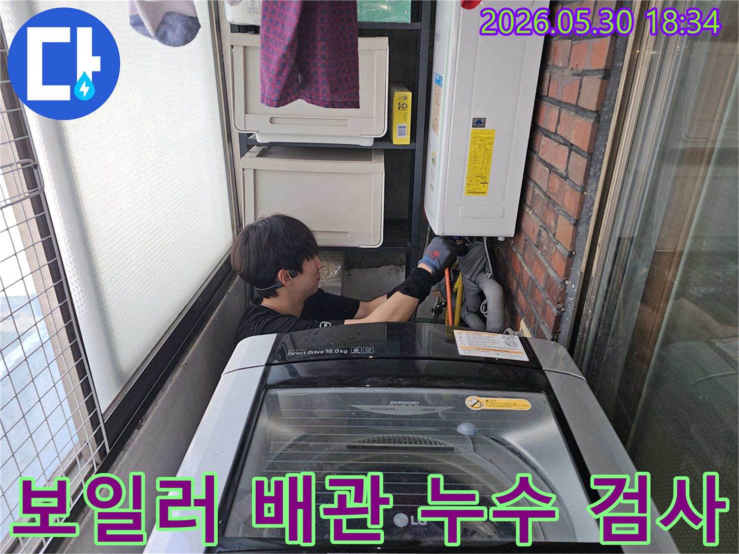 숙련된-엔지니어가-세탁실-좁은-공간에서-보일러-아래-배관의-미세한-누수-여부를-면밀히-살피고-있습니다