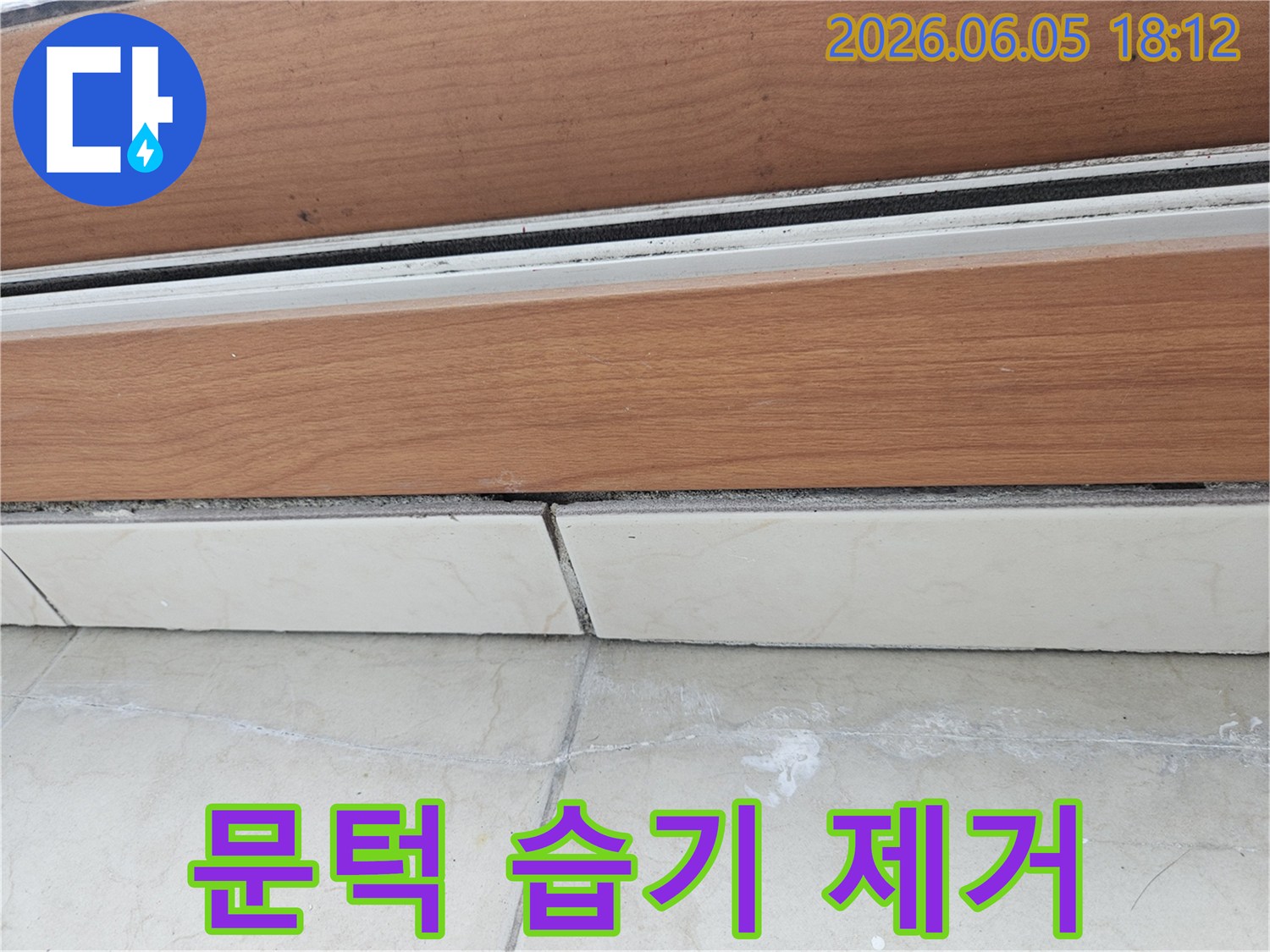 문턱-하단과-타일-경계선에-보이는-습기-흔적을-제거하고-방수-처리하기-위한-계획을-세우는-모습