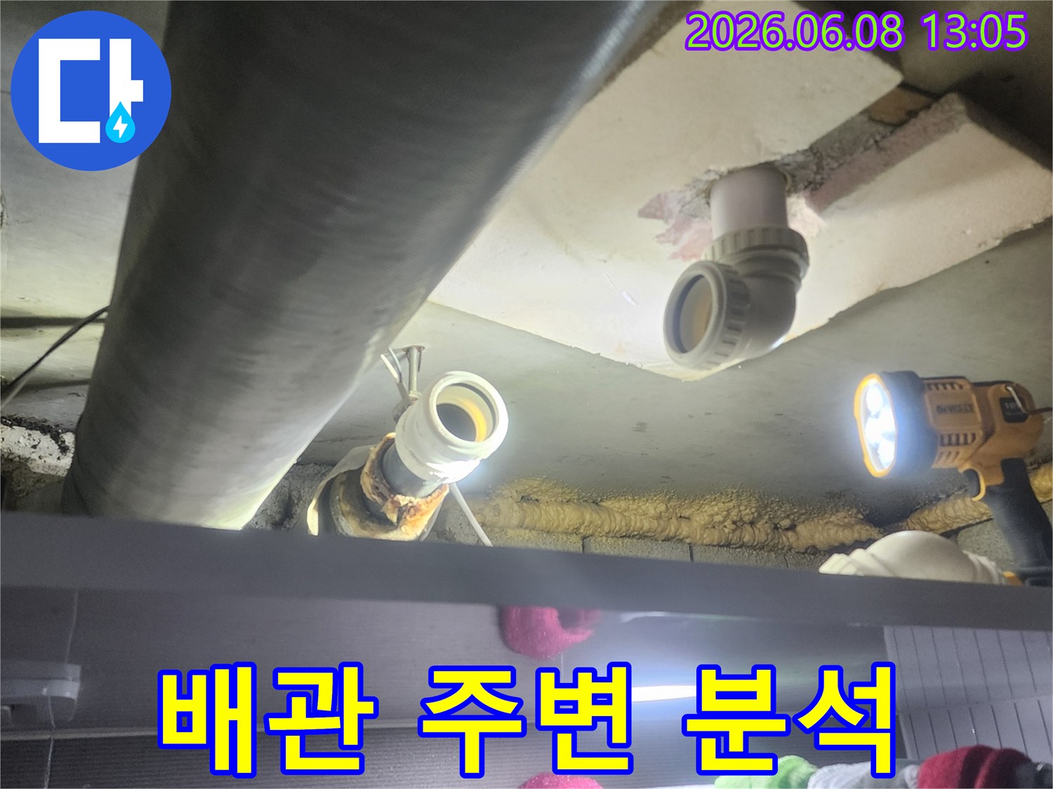 누수-전문가가-어두운-천장-속-배관-주변의-습기-및-손상-여부를-면밀히-분석하는-모습