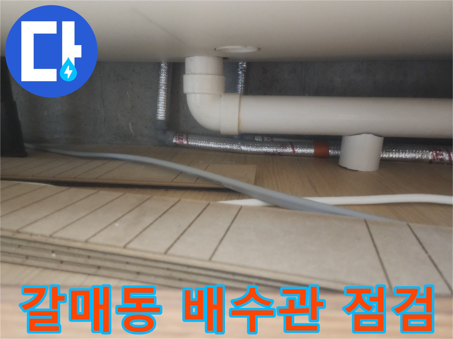 구리 갈매동 싱크대 하부장 내부의 흰색 배수관과 은색 자재 상태