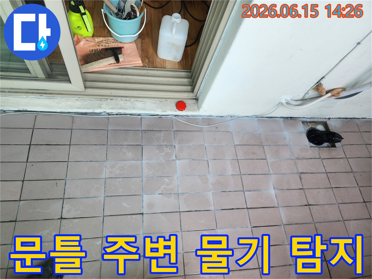 문틀 주변의 물기 흔적과-누수 탐지를 위한 장비들이 준비된 현장 사진입니다