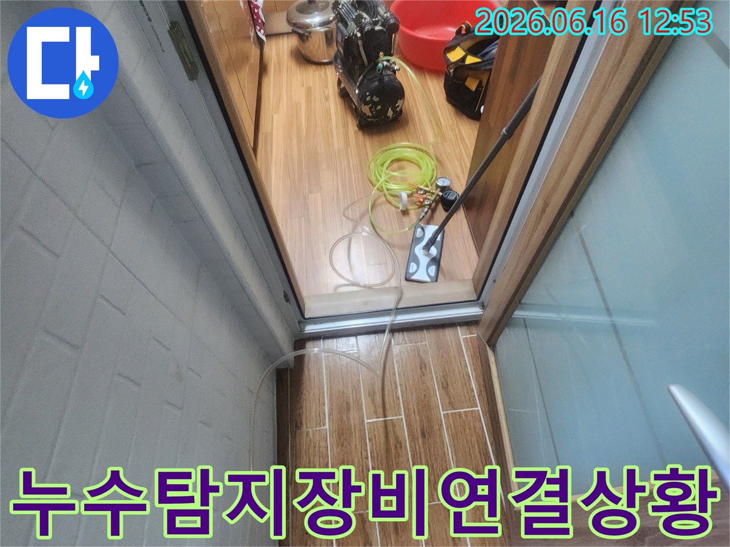 누수 엔지니어가 아파트 내부에서 누수-탐지 장비를 연결하며 현재 상황을 확인하고 있습니다.