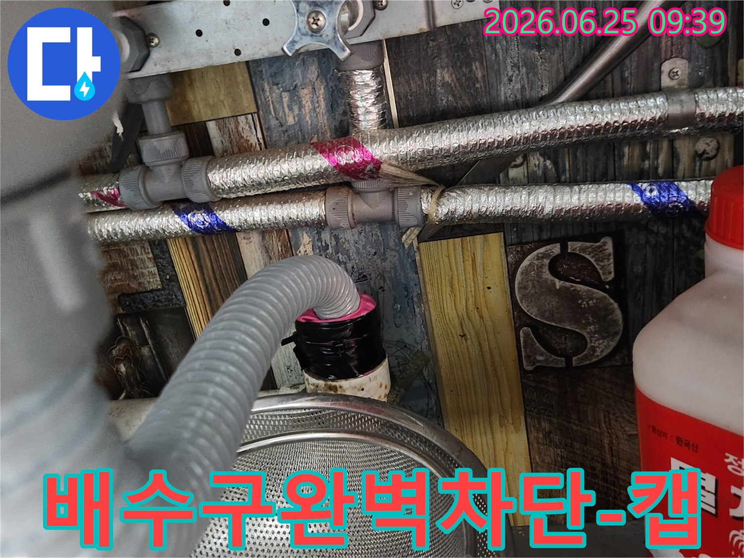 누수 원인 제거 후-세탁실 배수구에서 발생할 수 있는-모든 악취와 해충 유입을 완벽하게 막기 위해-특수 제작된 캡을 설치하는 최종 작업