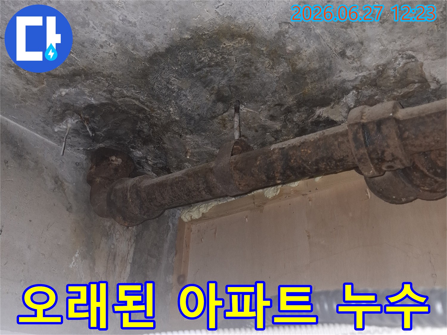 오래된 아파트의-녹슨 배관 주변에서-발견된 누수 흔적을-보여주는-젖은 콘크리트 바닥과-부식된 파이프의-상세 이미지입니다