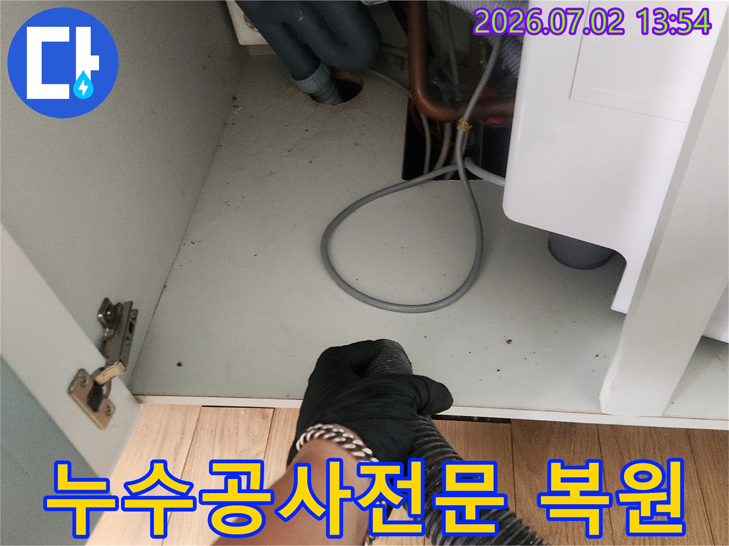 누수 공사 완료 후-작업자가 석션기를 사용하여-작업 현장을 깨끗하게 정리하는 모습