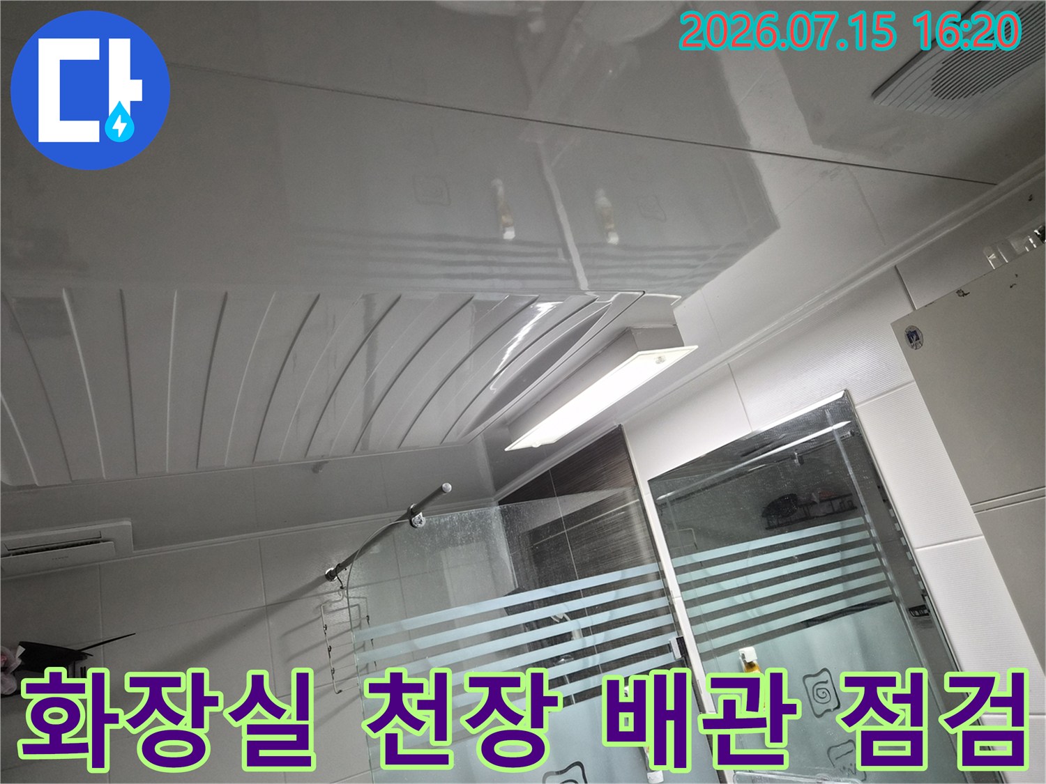 화장실 내부를 촬영한 천장 배관과 조명 설비 상태