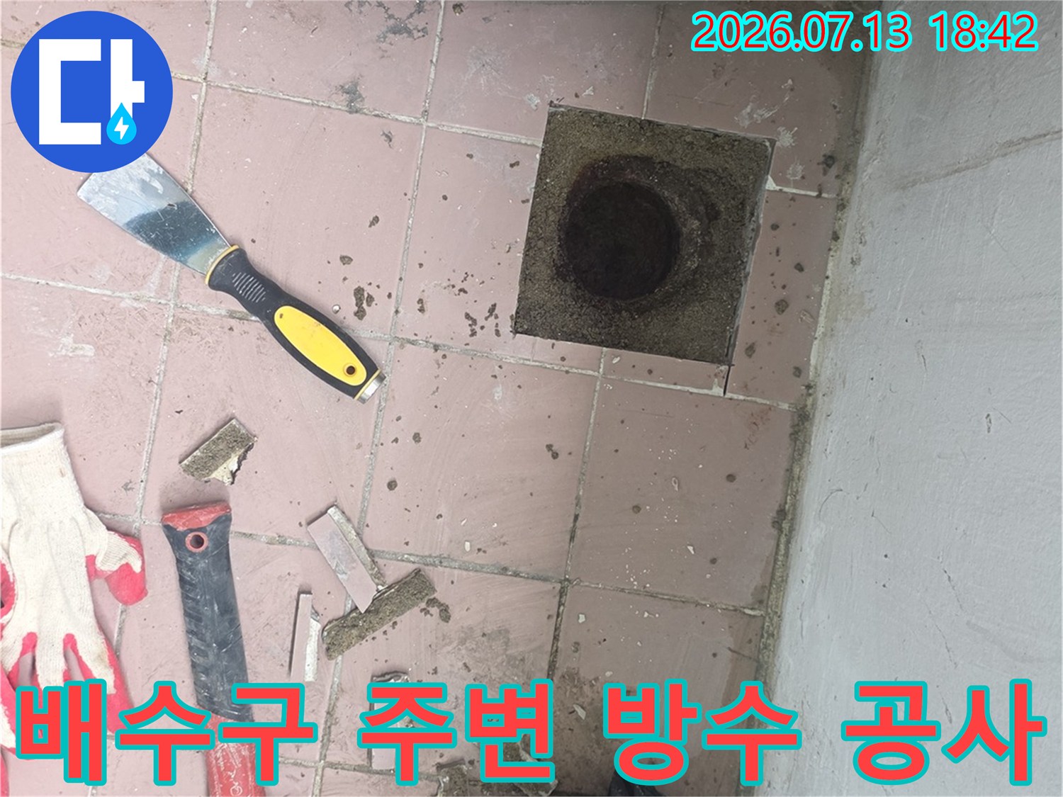 해체된 배수구 주변 타일과 각종 전문 장비가 놓인 작업 현장