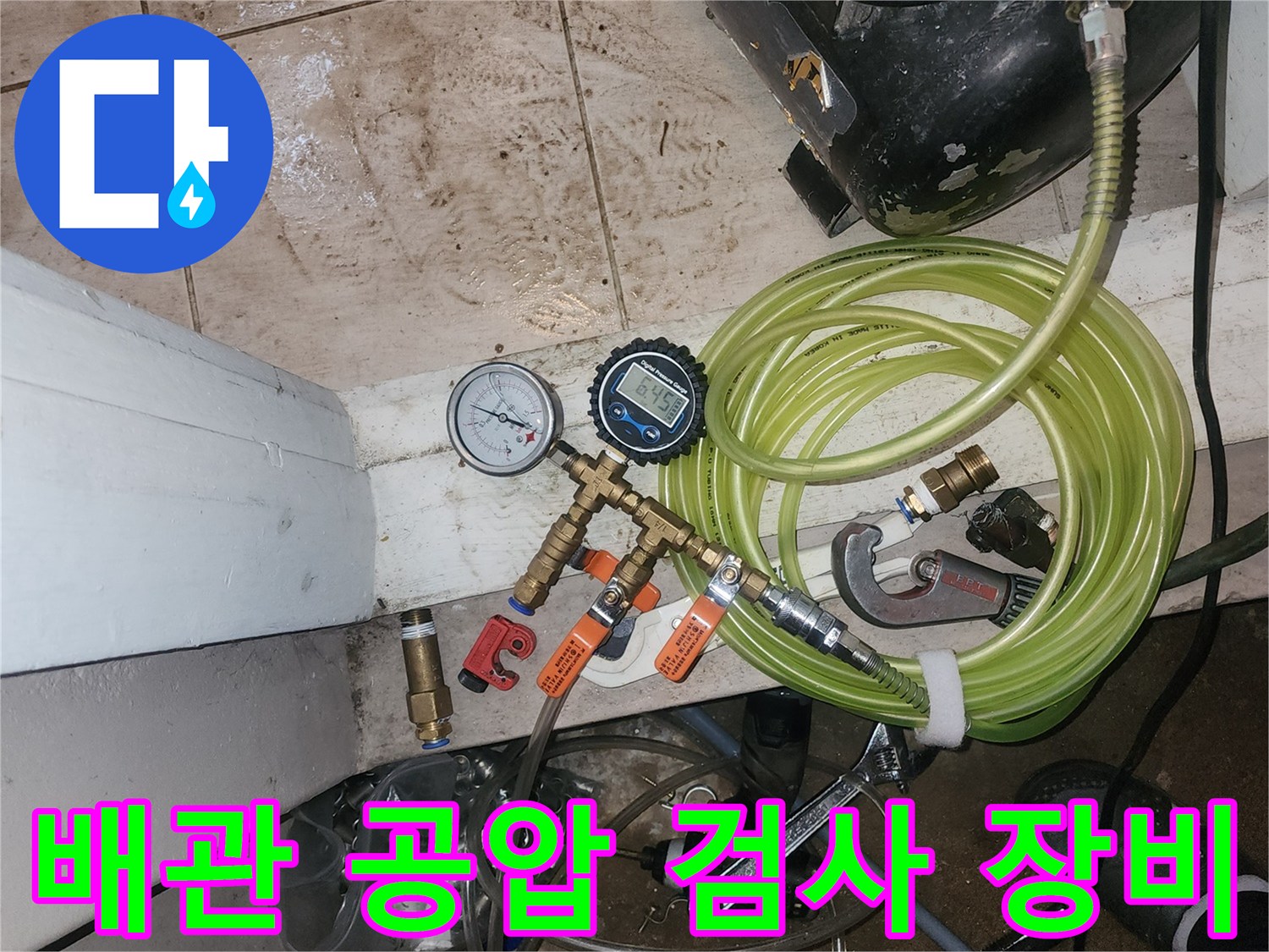 디지털 압력 게이지와 에어 호스가 연결된 배관 점검용 전문 장비 모습입니다.
