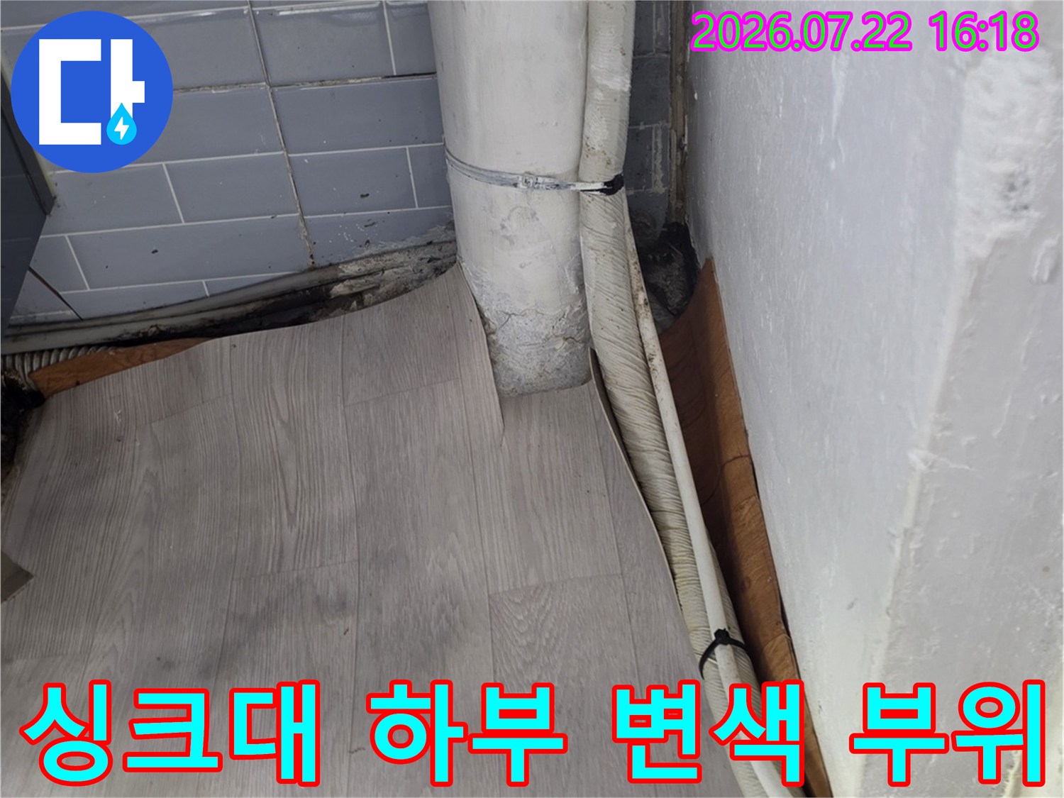 습기로 인해 곰팡이와 오염이 발생한 싱크대 하단 마감재와 타일 경계면