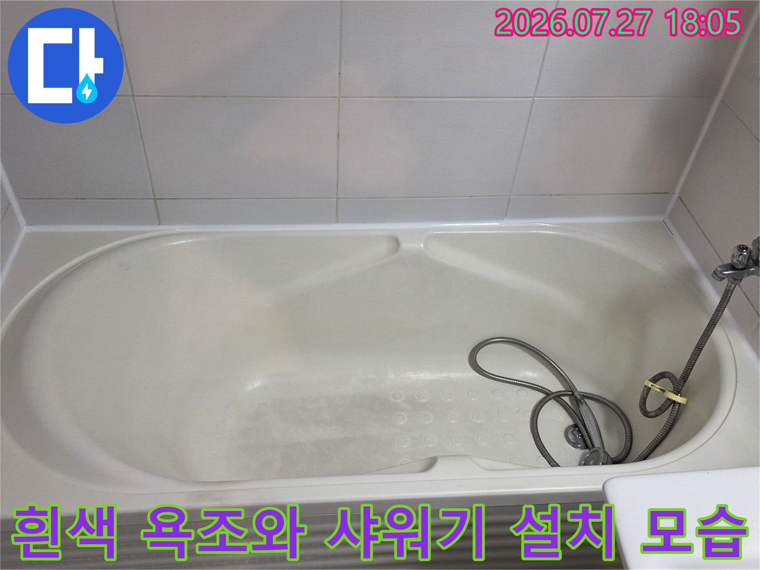 흰색 욕조와 벽면 타일 그리고 샤워 수전이 설치된 욕실 내부 사진