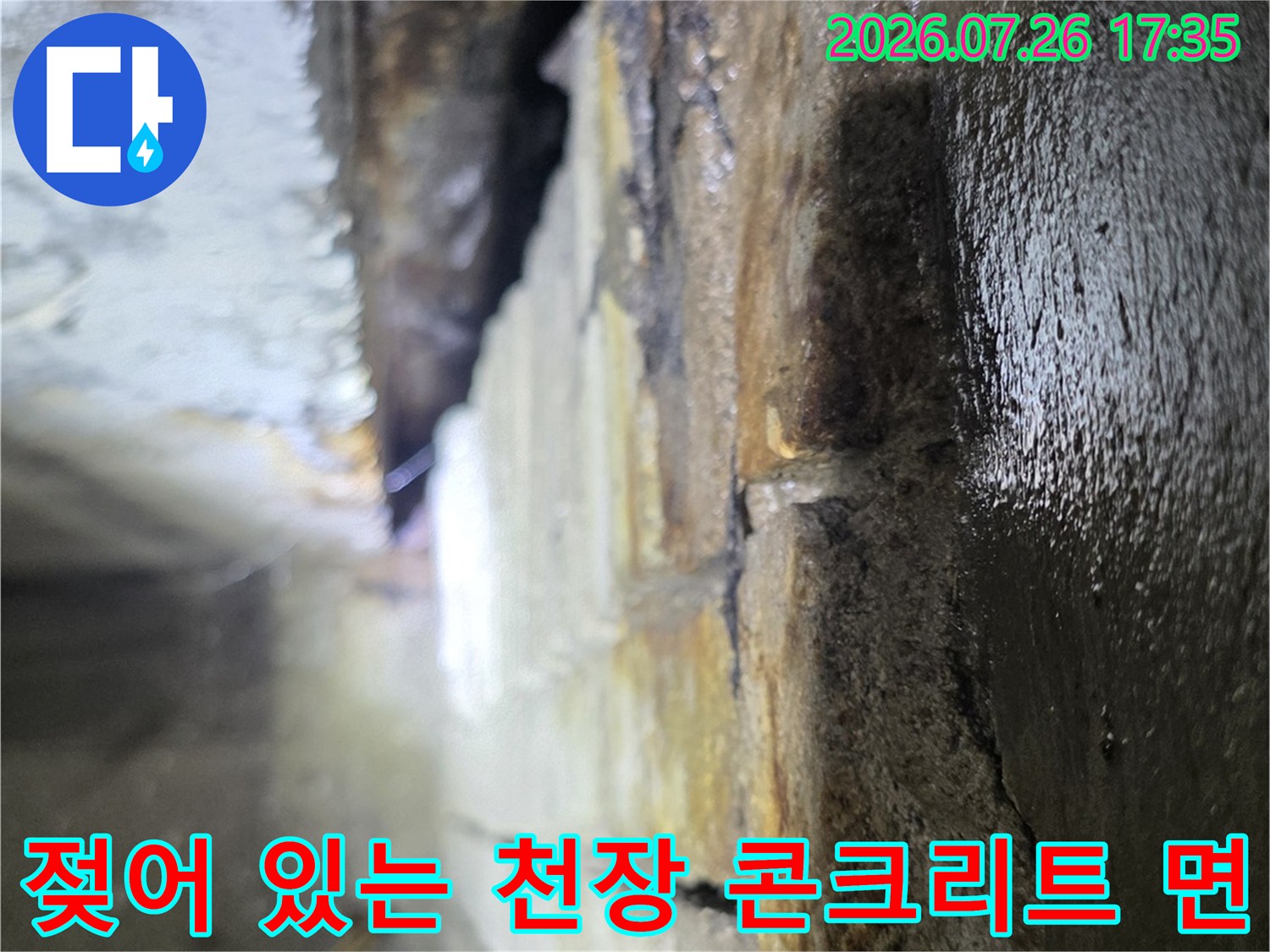 천장 내부의 젖은 콘크리트 표면과 물이 고여 반사되는 모습-상가 누수 피해 사진