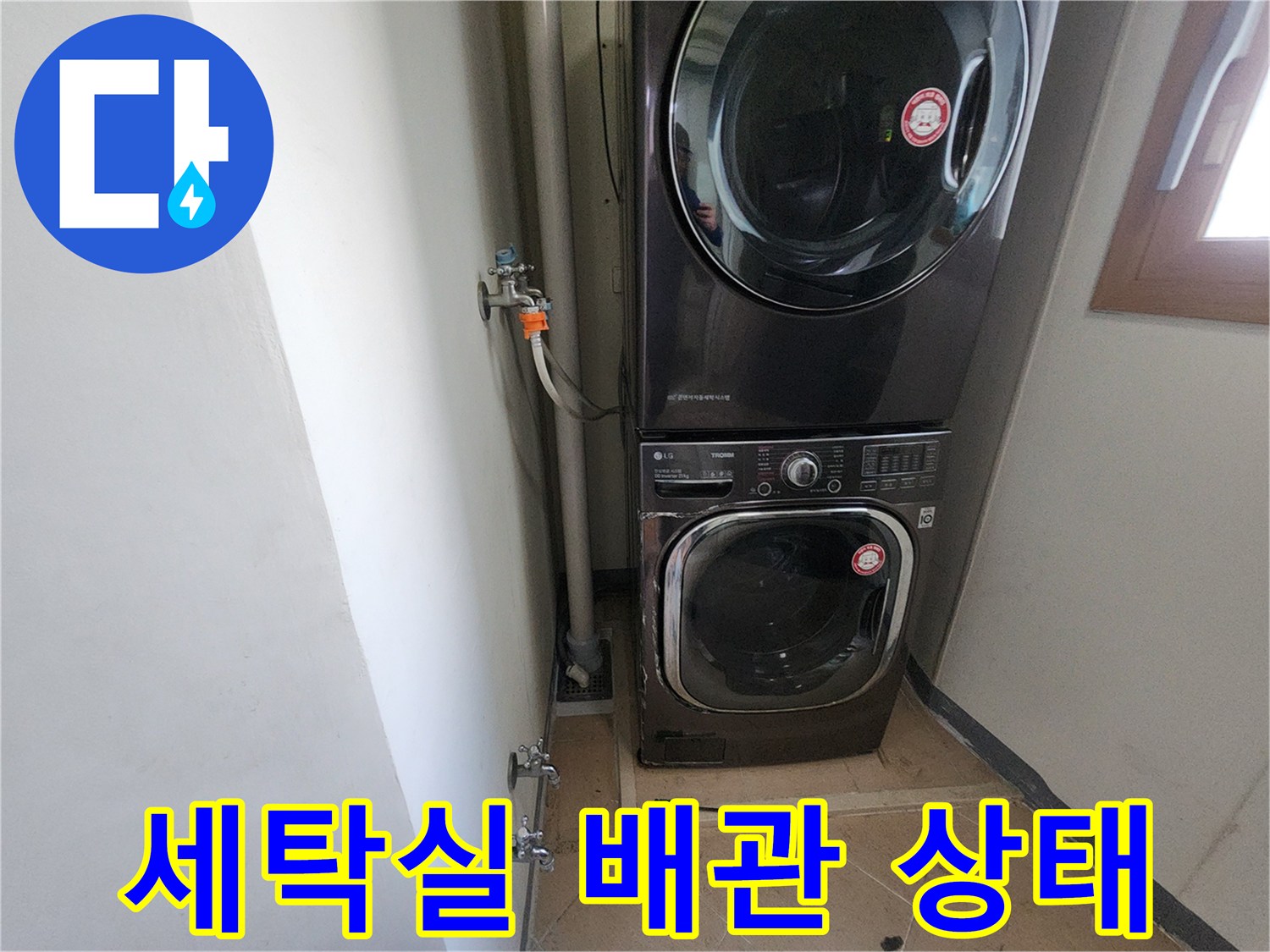 세탁기와 수도 배관이 연결된 세탁실 내부 모습