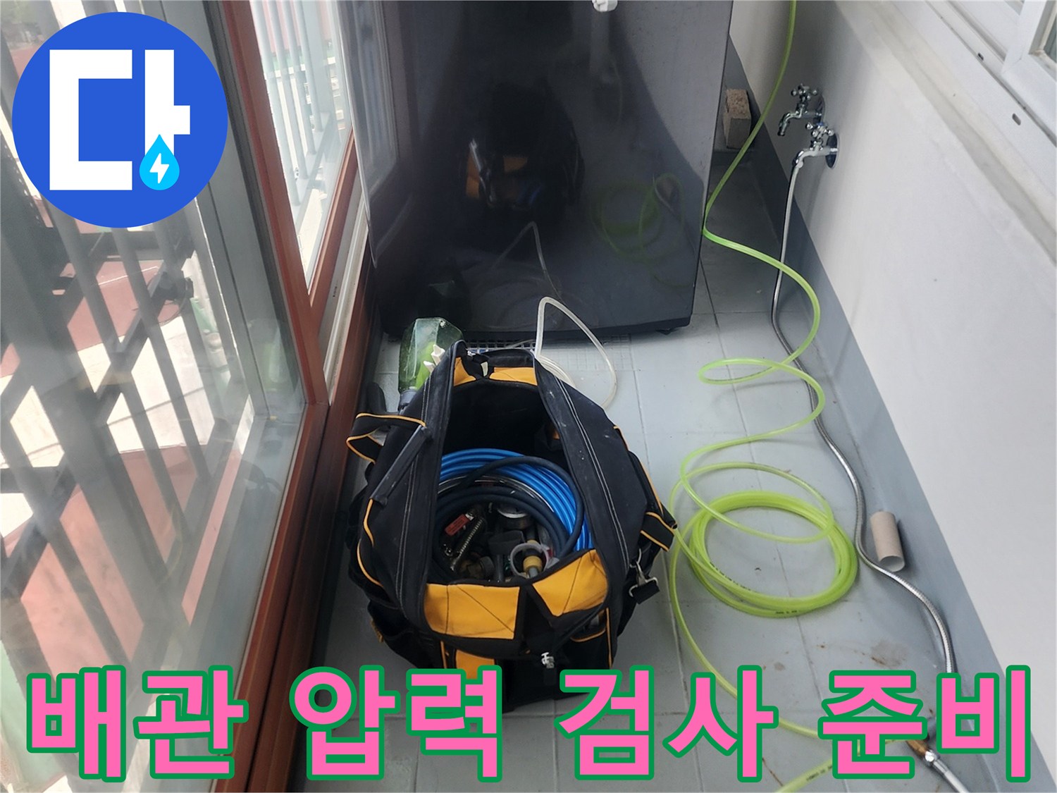 세탁실 바닥에 놓인 누수 진단용 공압 테스트 장비와 연결 호스