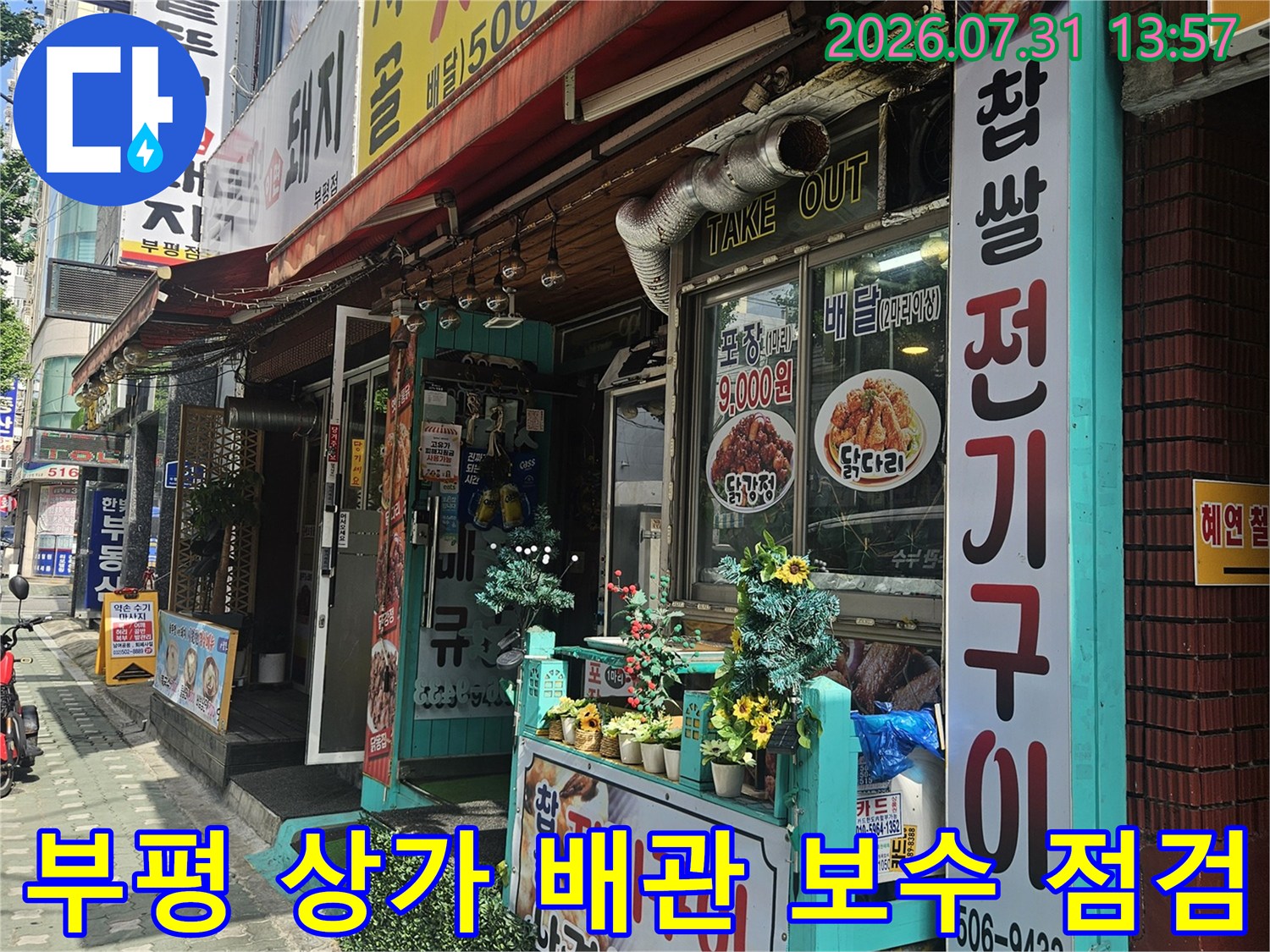 상가 건물 외벽에 위치한 수도계량기와 노후된 배관의 연결 상태