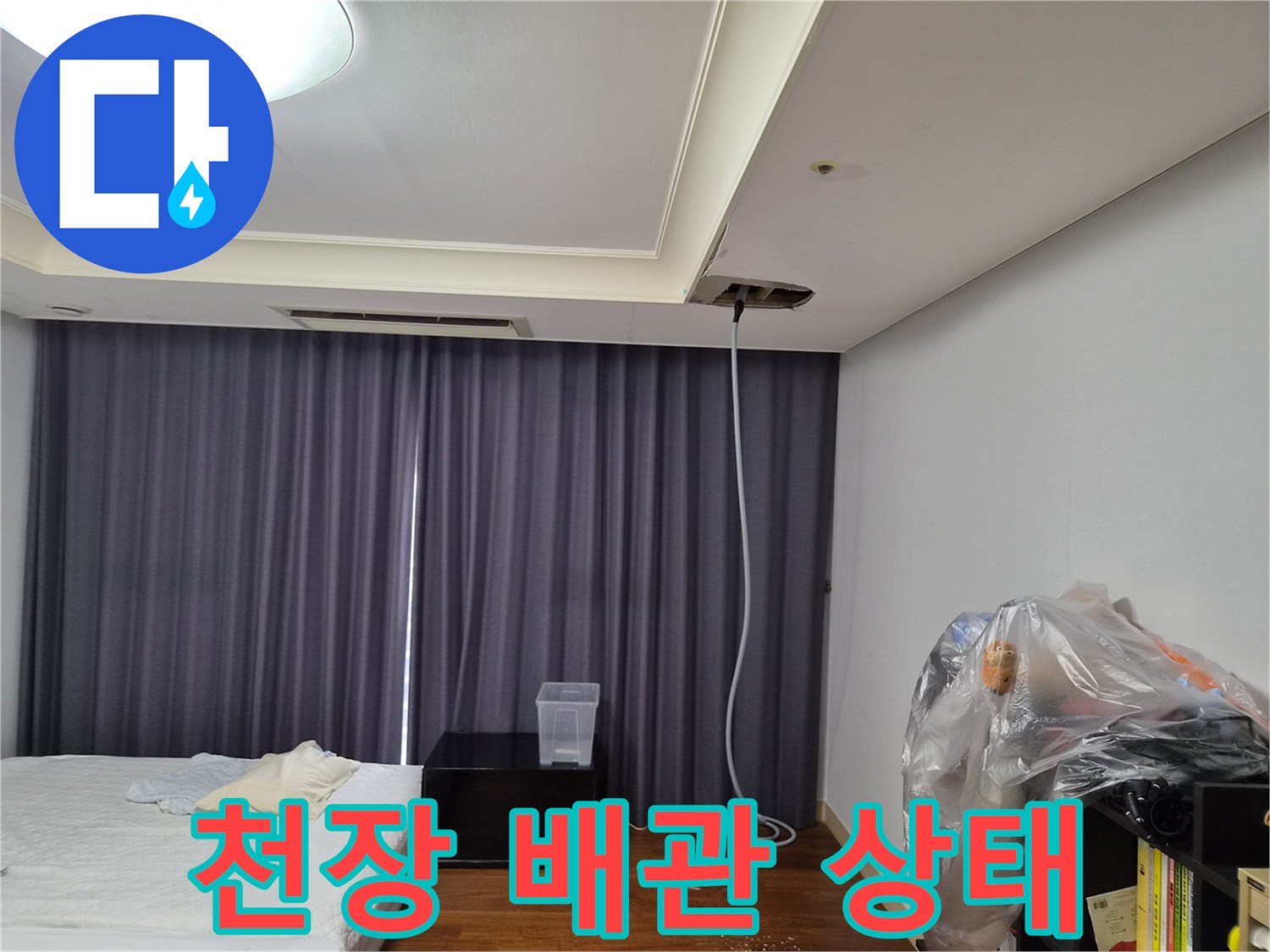천장 마감재 사이로 노출된 에어컨 배수 라인의 모습입니다.
