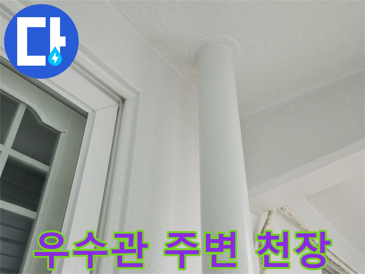 천장에 설치된 하얀색 우수관과 벽면 마감재 근접 촬영