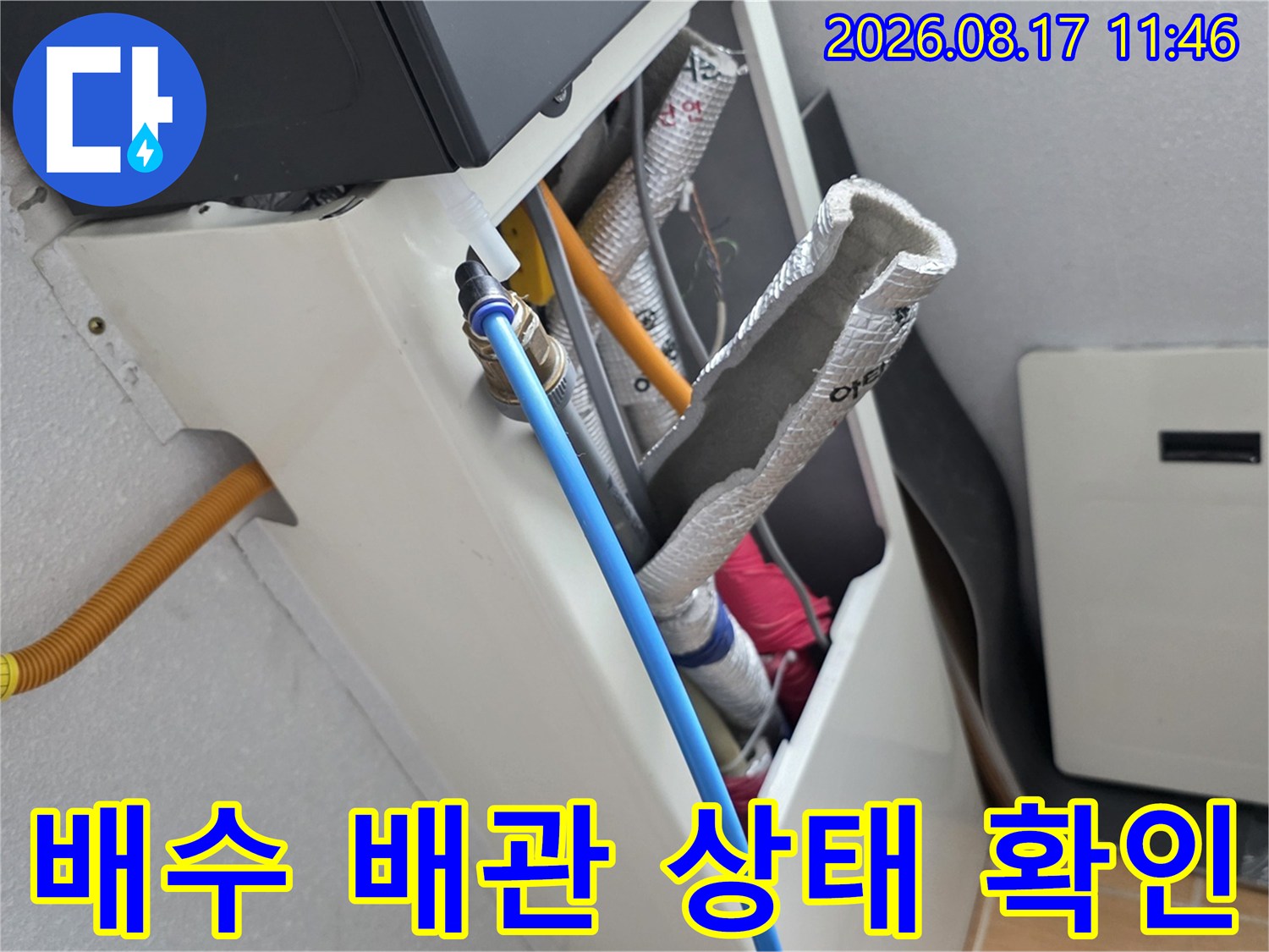 은박 보온재가 감겨 있는 배수관과 연결된 파란색 급수 호스 모습