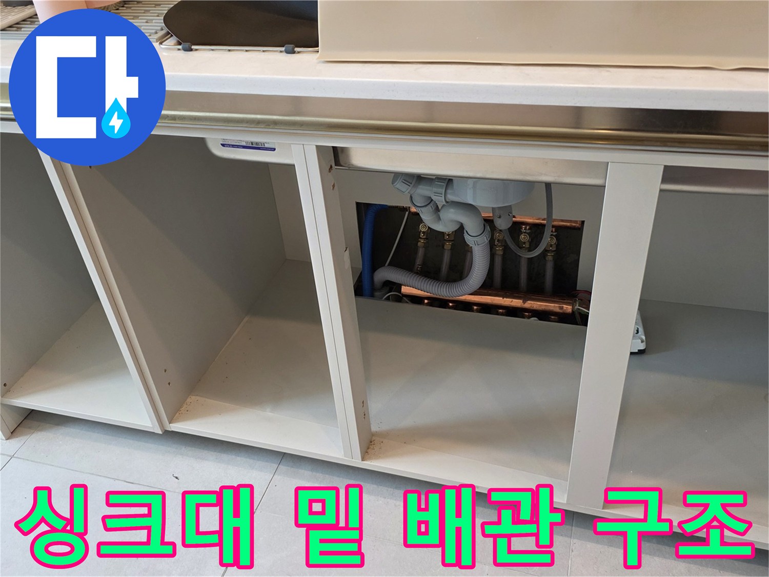 싱크대 하부장-안쪽의 복잡한 배관 연결 상태를 보여주는 사진입니다.
