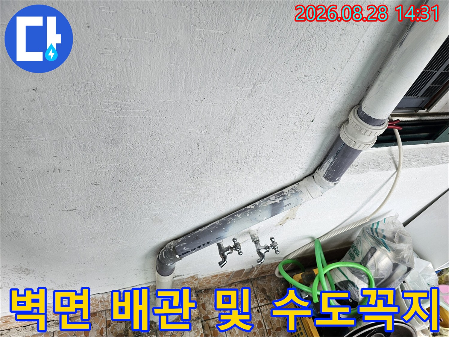 베란다 벽면에 돌출된 수도 배관과 연결된 수도꼭지 근접 촬영