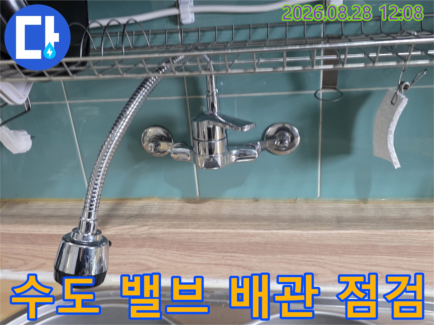 벽면에 설치된 주방용 수도 밸브와 수전 호스 연결 부위