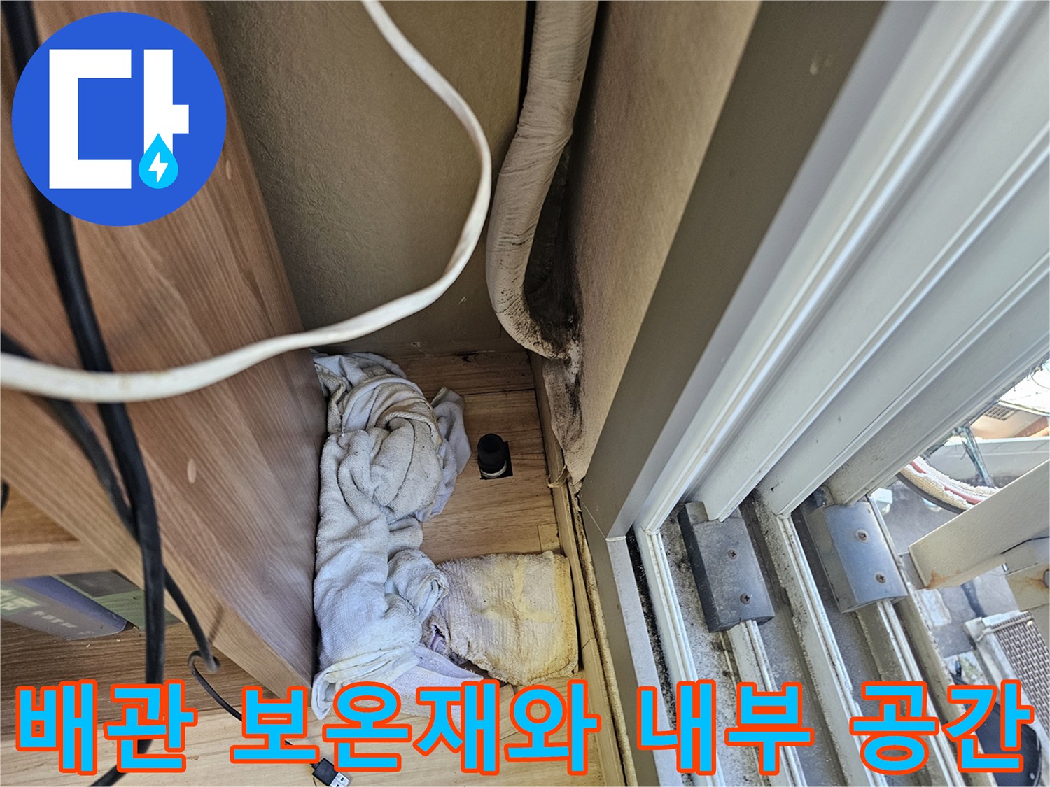 천장 구조물 사이로 노출된 배관과 주변 자재의 모습입니다.