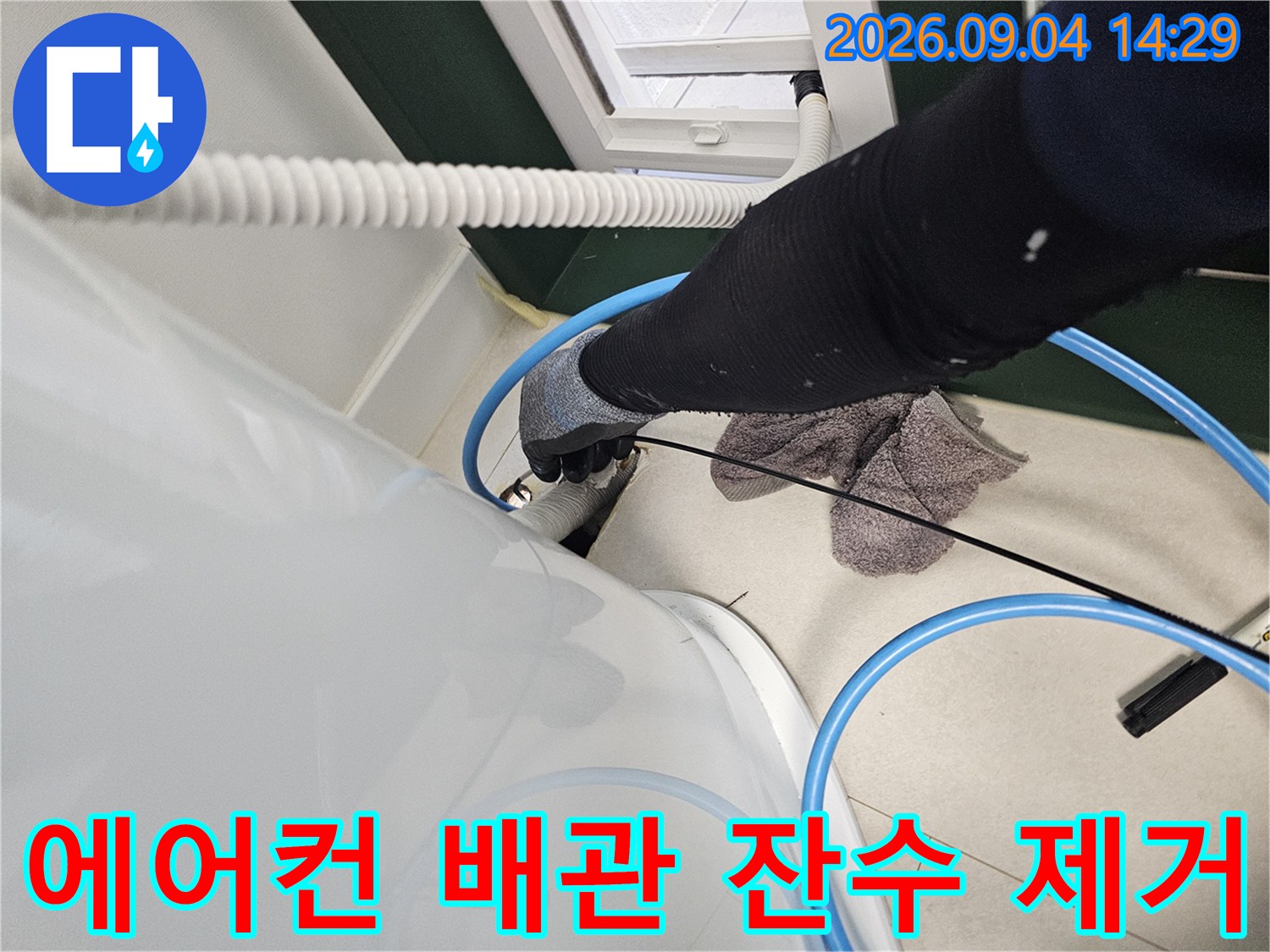 에어컨 매립 배관 내부의 고인 물을 흡입 장비로 제거하는 작업 현장