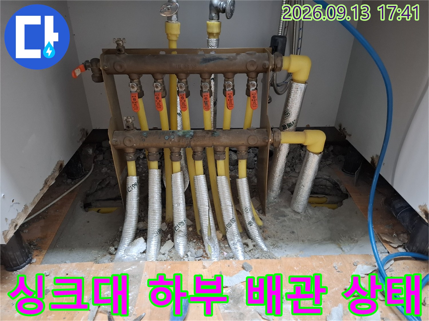 분배기에서 뻗어 나오는 노란색 배관과 은박 보온재로 감싸진 연결 부위입니다.